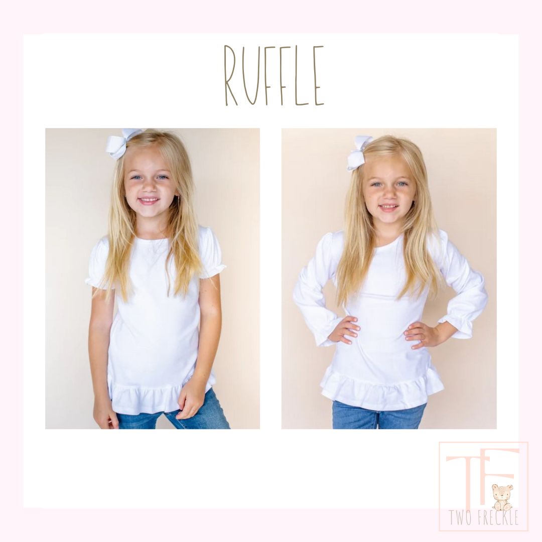 a little girl wearing a white ruffle top